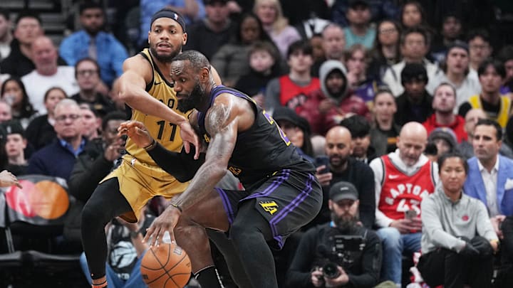 Apr 2, 2024; Toronto, Ontario, CAN; Los Angeles Lakers forward LeBron James (23) controls the ball as Toronto Raptors forward Bruce Brown (11) tries to defend during the third quarter at Scotiabank Arena. Mandatory Credit: Nick Turchiaro-Imagn Images