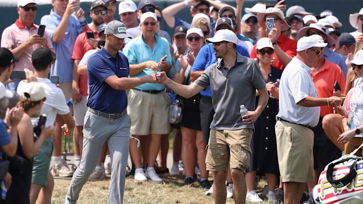 Victor Perez is congratulated by a fan after he plays his shot during the first round of the U.S. Open golf tournament Victor Perez is congratulated by a fan after he plays his shot during the first round of the U.S. Open golf tournament