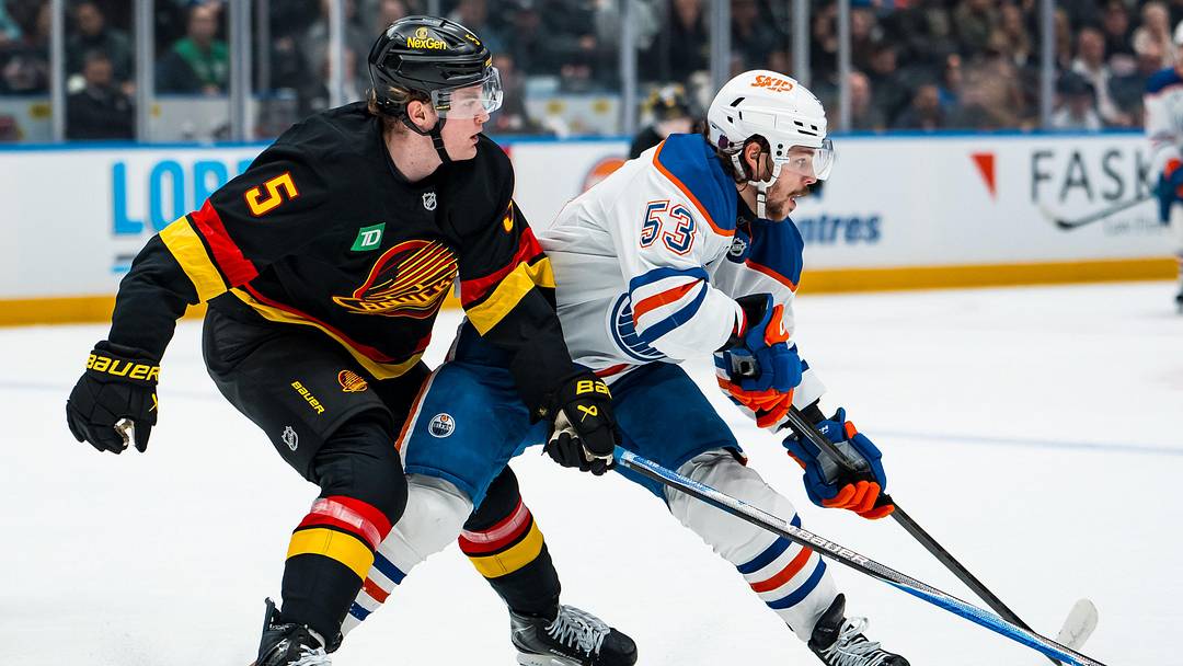Jan 17, 2026; Vancouver, British Columbia, CAN; Vancouver Canucks defenseman Tom Willander (5) battles with Edmonton Oilers forward Isaac Howard (53) in the first period at Rogers Arena. Mandatory Credit: Bob Frid-Imagn Images