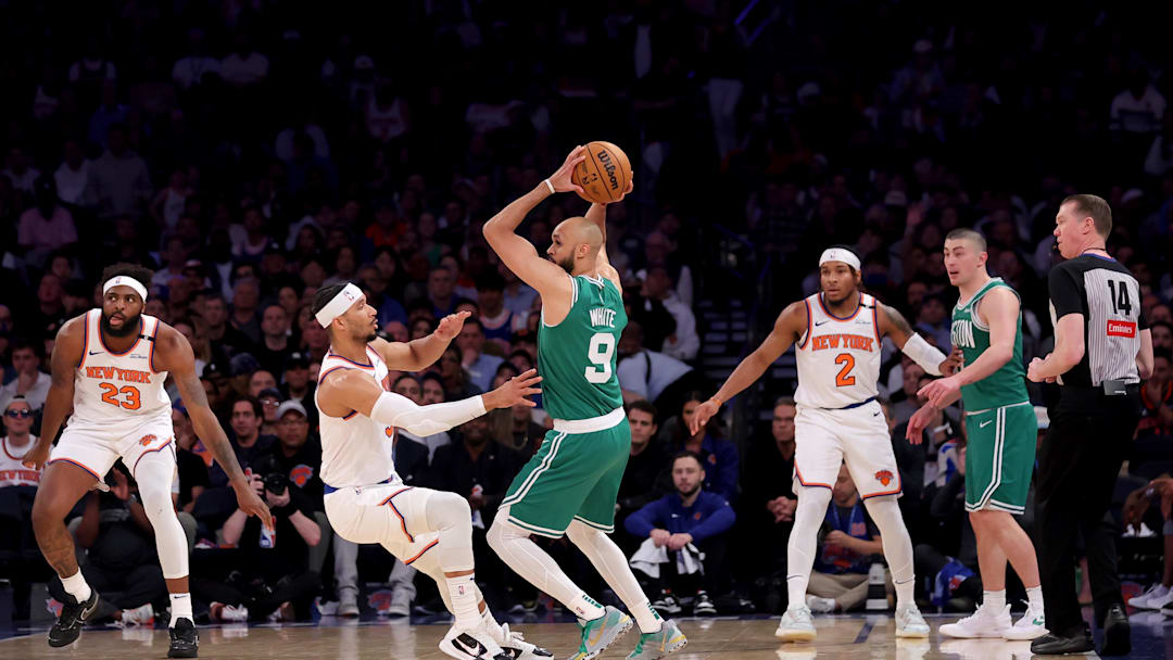May 16, 2025; New York, New York, USA; Boston Celtics guard Derrick White (9) controls the ball against New York Knicks guard Josh Hart (3) and center Mitchell Robinson (23) and guard Miles McBride (2) during the second quarter of game six in the second round of the 2025 NBA Playoffs at Madison Square Garden. Mandatory Credit: Brad Penner-Imagn Images