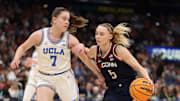 Apr 4, 2025; Tampa, FL, USA;  Connecticut Huskies guard Paige Bueckers (5) dribbles against UCLA Bruins guard Elina Aarnisalo (7) during the third quarter in a semifinal of the women's 2025 NCAA tournament at Amalie Arena. Mandatory Credit: Nathan Ray Seebeck-Imagn Images