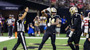 Sep 14, 2025; New Orleans, Louisiana, USA;  New Orleans Saints wide receiver Devaughn Vele (14) reacts to scoring a touchdown against San Francisco 49ers safety Jason Pinnock (25) during the second half at Caesars Superdome. Mandatory Credit: Stephen Lew-Imagn Images