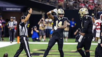 Sep 14, 2025; New Orleans, Louisiana, USA;  New Orleans Saints wide receiver Devaughn Vele (14) reacts to scoring a touchdown against San Francisco 49ers safety Jason Pinnock (25) during the second half at Caesars Superdome. Mandatory Credit: Stephen Lew-Imagn Images