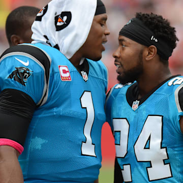 Oct 4, 2015; Tampa, FL, USA; Carolina Panthers defensive back Josh Norman (24) celebrates with Carolina Panthers quarterback Cam Newton (1) after a interception return for touchdown in the first half against the Tampa Bay Buccaneers at Raymond James Stadium. Mandatory Credit: Jonathan Dyer-Imagn Images