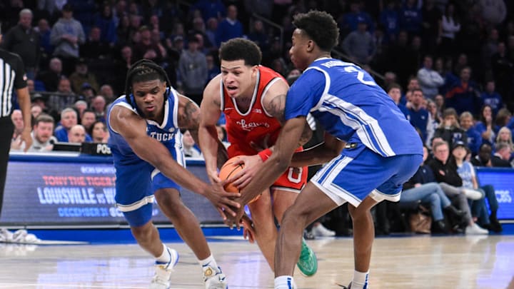 Dec 21, 2024; New York, New York, USA; Ohio State Buckeyes guard John Mobley Jr. (0) drives to the basket while being defended by Kentucky Wildcats guard Otega Oweh (00) and Kentucky Wildcats guard Jaxson Robinson (2) during the second half at Madison Square Garden. Mandatory Credit: John Jones-Imagn Images