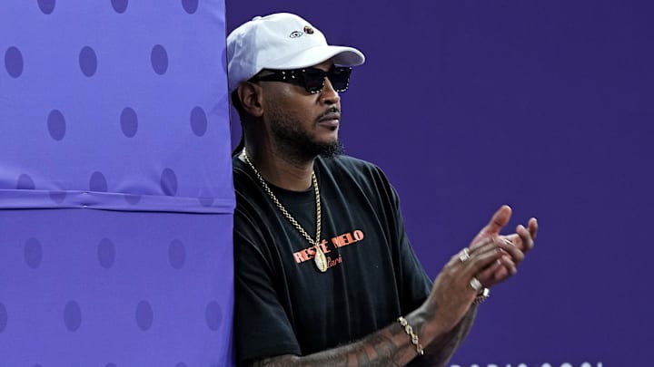 Carmelo Anthony watches Olympic 3x3 basketball in 2024. Carmelo Anthony watches Olympic 3x3 basketball in 2024.