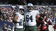 Nov 16, 2024; Annapolis, Maryland, USA;  Tulane Green Wave running back Makhi Hughes (21) celebrates with  offensive lineman Vincent Murphy (64) after scoring a touchdown against the Navy Midshipmen at Navy-Marine Corps Memorial Stadium. Mandatory Credit: Tommy Gilligan-Imagn Images