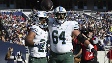 Nov 16, 2024; Annapolis, Maryland, USA;  Tulane Green Wave running back Makhi Hughes (21) celebrates with  offensive lineman Vincent Murphy (64) after scoring a touchdown against the Navy Midshipmen at Navy-Marine Corps Memorial Stadium. Mandatory Credit: Tommy Gilligan-Imagn Images