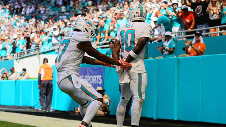 Miami Dolphins receiver Tyreek Hill celebrates a touchdown with a handcuff celebration with his teammate Jaylen Waddle.