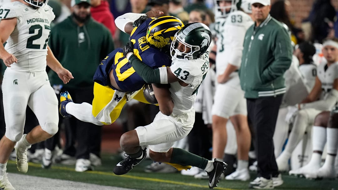 Michigan quarterback Alex Orji (10) is brought down by Michigan State defensive back Malik Spencer (43) during the second half at Michigan Stadium in Ann Arbor on Saturday, Oct. 26, 2024. Michigan quarterback Alex Orji (10) is brought down by Michigan State defensive back Malik Spencer (43) during the second half at Michigan Stadium in Ann Arbor on Saturday, Oct. 26, 2024.