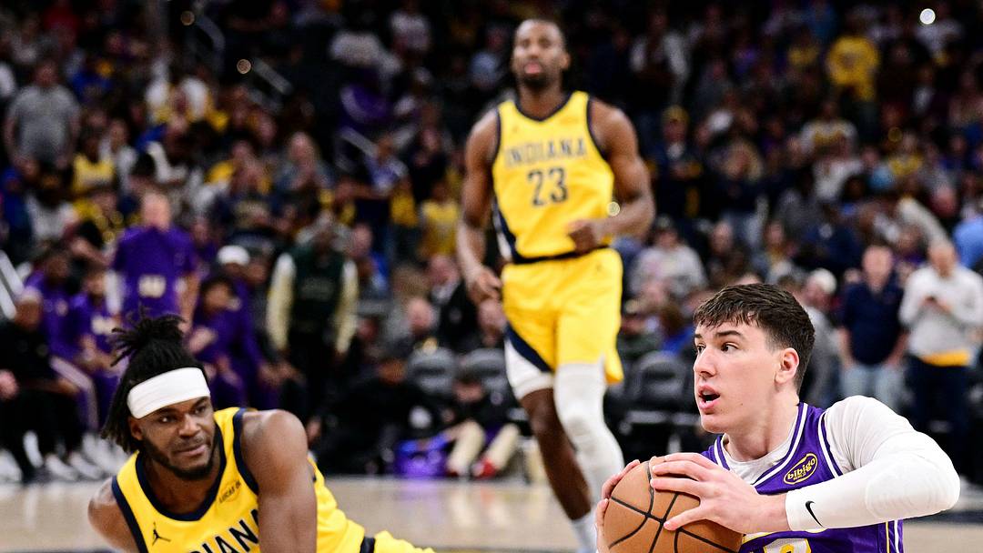 Mar 25, 2026; Indianapolis, Indiana, USA; Los Angeles Lakers forward Jake LaRavia (12) passes a loose ball away from Indiana Pacers forward Jarace Walker (5) during the first quarter at Gainbridge Fieldhouse. Mandatory Credit: Marc Lebryk-Imagn Images
