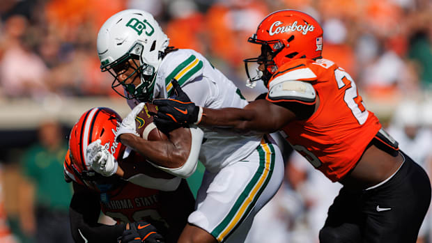 Baylor Bears wide receiver Josh Cameron (34) is tackled by Oklahoma State Cowboys linebacker Ike Esonwune