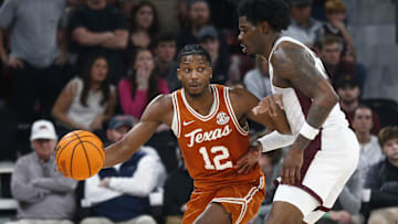 Mar 4, 2025; Starkville, Mississippi, USA; Texas Longhorns guard Tramon Mark (12) dribbles as Mississippi State Bulldogs forward Cameron Matthews (4) defends during the second half at Humphrey Coliseum. Mandatory Credit: Petre Thomas-Imagn Images