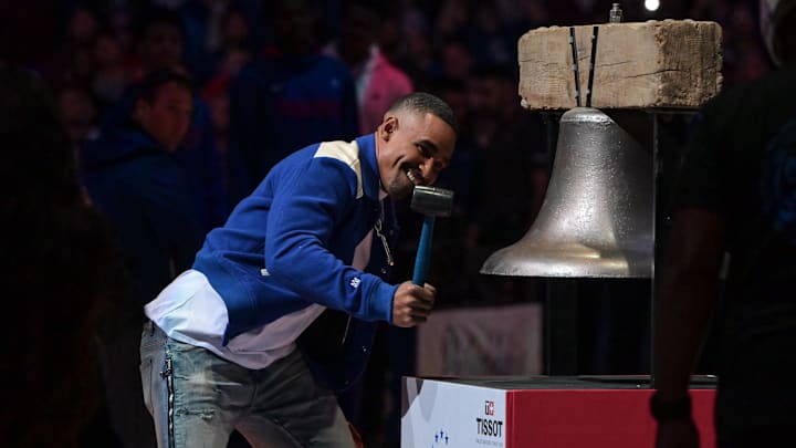 Oct 22, 2022; Philadelphia, Pennsylvania, USA;  Philadelphia Eagles quarterback Jalen Hurts rings the bell before the game between the Philadelphia 76ers and the San Antonio Spurs at Wells Fargo Center. Mandatory Credit: John Geliebter-Imagn Images