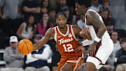 Mar 4, 2025; Starkville, Mississippi, USA; Texas Longhorns guard Tramon Mark (12) dribbles as Mississippi State Bulldogs forward Cameron Matthews (4) defends during the second half at Humphrey Coliseum. Mandatory Credit: Petre Thomas-Imagn Images