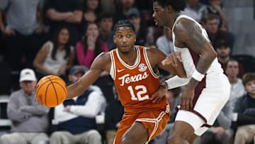 Mar 4, 2025; Starkville, Mississippi, USA; Texas Longhorns guard Tramon Mark (12) dribbles as Mississippi State Bulldogs forward Cameron Matthews (4) defends during the second half at Humphrey Coliseum. Mandatory Credit: Petre Thomas-Imagn Images