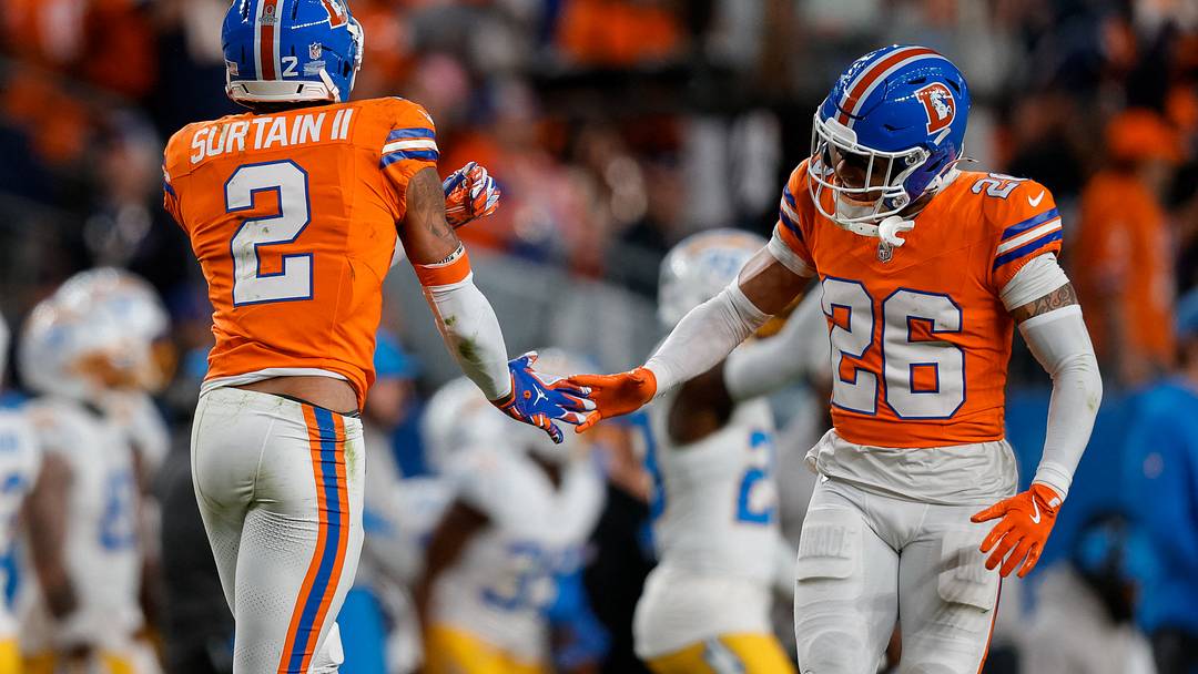 Jan 4, 2026; Denver, Colorado, USA; Denver Broncos cornerback Pat Surtain II (2) reacts with safety Devon Key (26) after a play in the fourth quarter against the Los Angeles Chargers at Empower Field at Mile High. Mandatory Credit: Isaiah J. Downing-Imagn Images