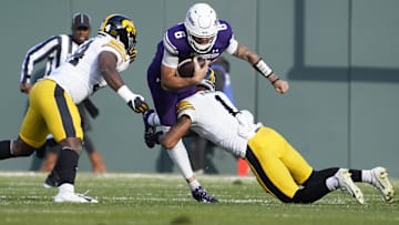 Nov 4, 2023; Chicago, Illinois, USA; Iowa Hawkeyes defensive back Xavier Nwankpa (1) tackles Northwestern Wildcats quarterback Brendan Sullivan (6) during the first half at Wrigley Field. Mandatory Credit: David Banks-Imagn Images