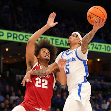 Feb 9, 2025; Memphis, Tennessee, USA; Memphis Tigers guard Dante Harris (5) shoots the ball against Temple Owls forward Elijah Gray (22), who transferred to the Wisconsin Badgers.