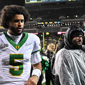 Nov 8, 2025; Iowa City, Iowa, USA; Oregon Ducks quarterback Dante Moore (5) runs off the field after the game against the Iowa Hawkeyes at Kinnick Stadium. Mandatory Credit: Jeffrey Becker-Imagn Images