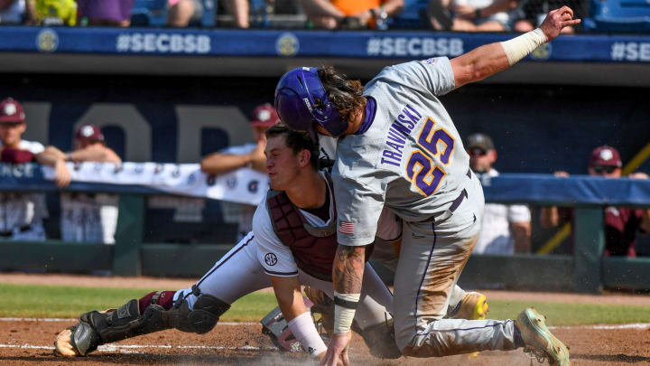 New South Carolina baseball catcher Max Kaufer tagging out LSU's Hayden Travinski during a play at the plate.