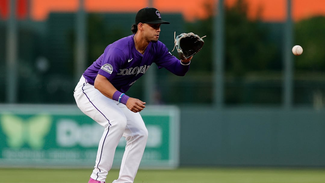 Sep 3, 2025; Denver, Colorado, USA; Colorado Rockies shortstop Ezequiel Tovar (14) fields the ball in the second inning against the San Francisco Giants at Coors Field. Mandatory Credit: Isaiah J. Downing-Imagn Images