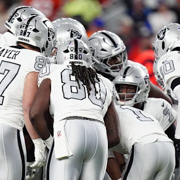 Nov 6, 2025; Denver, Colorado, USA; The Las Vegas Raiders huddle up against the Denver Broncos during the first half at Empower Field at Mile High. Mandatory Credit: Ron Chenoy-Imagn Images