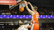 Dec 6, 2024; Evanston, Illinois, USA; Illinois Fighting Illini center Tomislav Ivisic (13) dunks the ball on Northwestern Wildcats center Matthew Nicholson (34) during the first half at Welsh-Ryan Arena. Mandatory Credit: David Banks-Imagn Images