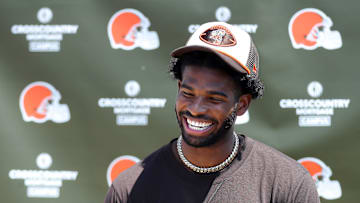 Cleveland Browns quarterback Shedeur Sanders (12) jokes about his signing bonus during a press conference before day two of NFL rookie minicamp at the Cleveland Browns training facility on Saturday, May 10, 2025, in Berea, Ohio.