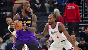 Jan 19, 2025; Inglewood, California, USA; Los Angeles Lakers forward LeBron James (23) moves the ball against Los Angeles Clippers forward Kawhi Leonard (2) during the first half at Intuit Dome. 