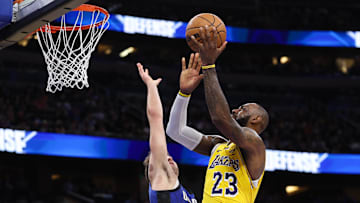 Mar 24, 2025; Orlando, Florida, USA; Los Angeles Lakers forward LeBron James (23) drives to the basket against the Orlando Magic in the second quarter at Kia Center. Mandatory Credit: Nathan Ray Seebeck-Imagn Images