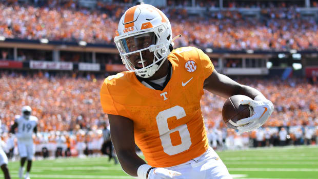 Tennessee Volunteers running back Dylan Sampson scores a touchdown during a college football game in the SEC.