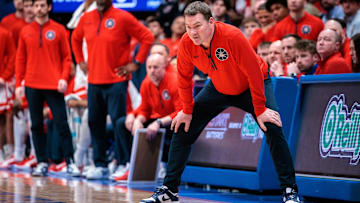 Arizona Wildcats coach Tommy Lloyd watches game play during the second half against the Kansas Jayhawks at Allen Fieldhouse.