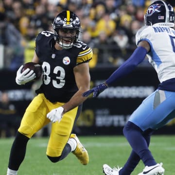 Nov 2, 2023; Pittsburgh, Pennsylvania, USA;  Pittsburgh Steelers tight end Connor Heyward (83) runs after a catch as Tennessee Titans cornerback Sean Murphy-Bunting (0) defends during the first quarter at Acrisure Stadium. Mandatory Credit: Charles LeClaire-USA TODAY Sports