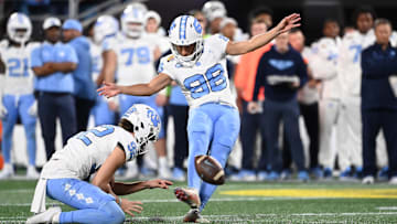 Dec 27, 2023; Charlotte, NC, USA; North Carolina Tar Heels place kicker Noah Burnette (98) kicks a field goal in the second quarter at Bank of America Stadium. Mandatory Credit: Bob Donnan-USA TODAY Sports