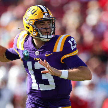 Jan 1, 2024; Tampa, FL, USA;  LSU Tigers quarterback Garrett Nussmeier (13) throws a pass against the Wisconsin Badgers in the third quarter during the ReliaQuest Bowl at Raymond James Stadium. Mandatory Credit: Nathan Ray Seebeck-USA TODAY Sports