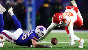 Jan 21, 2024; Orchard Park, New York, USA; Buffalo Bills tight end Dalton Kincaid (86) and Kansas City Chiefs wide receiver Nikko Remigio (27) attempt to revoker a fumble on special teams during the second half for the 2024 AFC divisional round game at Highmark Stadium. Mandatory Credit: Mark J. Rebilas-Imagn Images