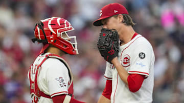 Cincinnati Reds catcher Jose Trevino talks with pitcher Brady Singer