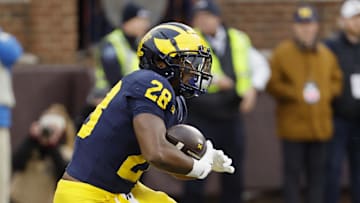 Nov 23, 2024; Ann Arbor, Michigan, USA;  Michigan Wolverines running back Benjamin Hall (28) runs the ball against the Northwestern Wildcats in the first half at Michigan Stadium. Mandatory Credit: Rick Osentoski-Imagn Images