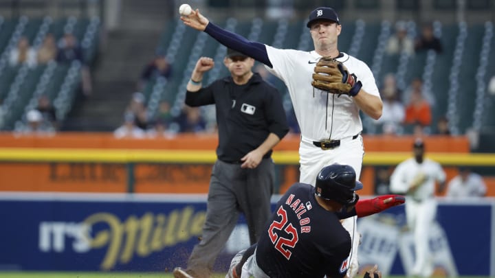 Jul 10, 2024; Detroit, Michigan, USA;  Detroit Tigers second baseman Colt Keith (33) makes a throw to first to complete a double play as Cleveland Guardians first baseman Josh Naylor (22) slides into second in the sixth inning at Comerica Park. Mandatory Credit: Rick Osentoski-USA TODAY Sports