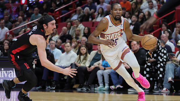Phoenix Suns forward Kevin Durant drives to the basket past Miami Heat guard Jaime Jaquez Jr.