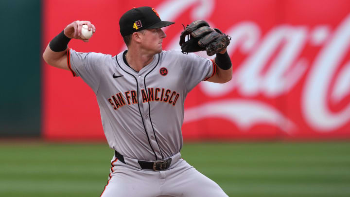 Aug 17, 2024; Oakland, California, USA; San Francisco Giants shortstop Tyler Fitzgerald (49) throws the ball to first base during the sixth inning against the Oakland Athletics at Oakland-Alameda County Coliseum.