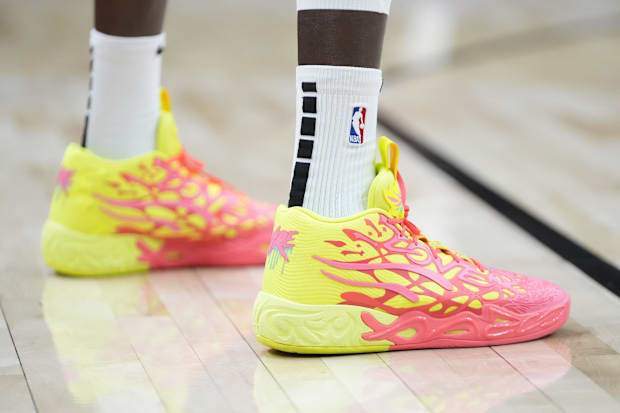 Toronto Raptors forward Chris Boucher's yellow and orange PUMA sneakers.