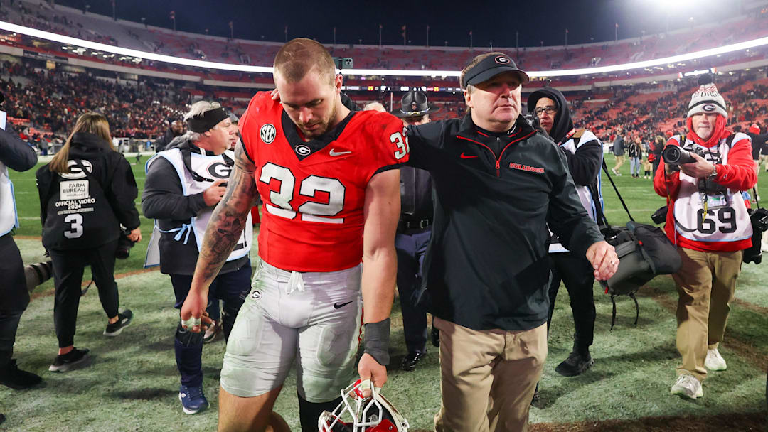 Nov 29, 2024; Athens, Georgia, USA; Georgia Bulldogs linebacker Chaz Chambliss (32) and head coach Kirby Smart walk off the field after an eight overtime victory over the Georgia Tech Yellow Jackets at Sanford Stadium. Mandatory Credit: Brett Davis-Imagn Images