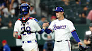 Jul 1, 2025; Arlington, Texas, USA;  Texas Rangers relief pitcher Jacob Latz (67) celebrates with Texas Rangers catcher Jonah Heim (28) after the game against the Baltimore Orioles at Globe Life Field. 