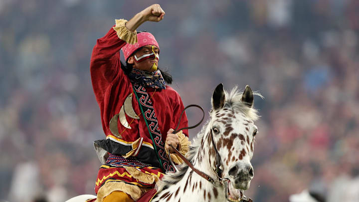 Dec 29, 2022; Orlando, Florida, USA; Florida State Seminoles Chief Osceola and horse Renegade entertain the crowd before the 2022 Cheez-It Bowl against the Oklahoma Sooners at Camping World Stadium. Mandatory Credit: Nathan Ray Seebeck-Imagn Images