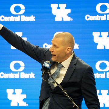 University of Kentucky’s new men’s basketball coach Mark Pope points to the championship banners as he speaks about the victories he will soon be adding to display.
