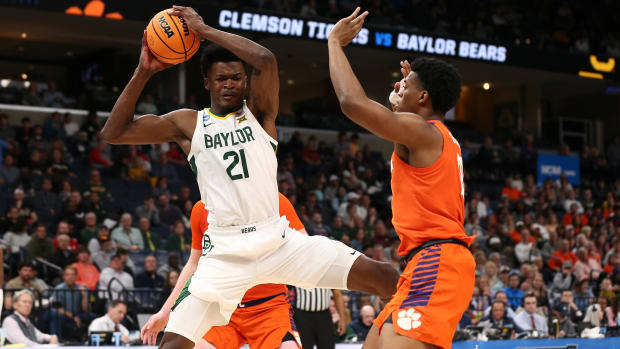 Mar 24, 2024; Memphis, TN, USA; Baylor Bears center Yves Missi (21) controls the ball against Clemson Tigers forward RJ Godfrey (10) in the second half in the second round of the 2024 NCAA Tournament at FedExForum. Mandatory Credit: Petre Thomas-USA TODAY Sports