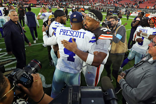 Cleveland Browns defensive end Myles Garrett hugs Dallas Cowboys quarterback Dak Prescott.