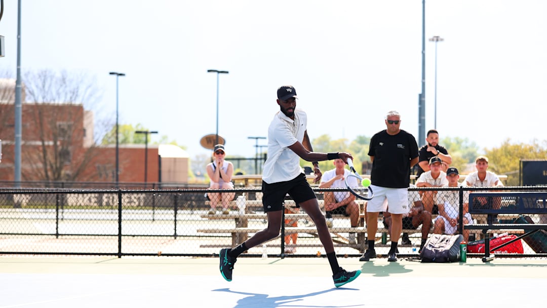 Wake Forest tennis player DK Suresh hits a shot against NC State 